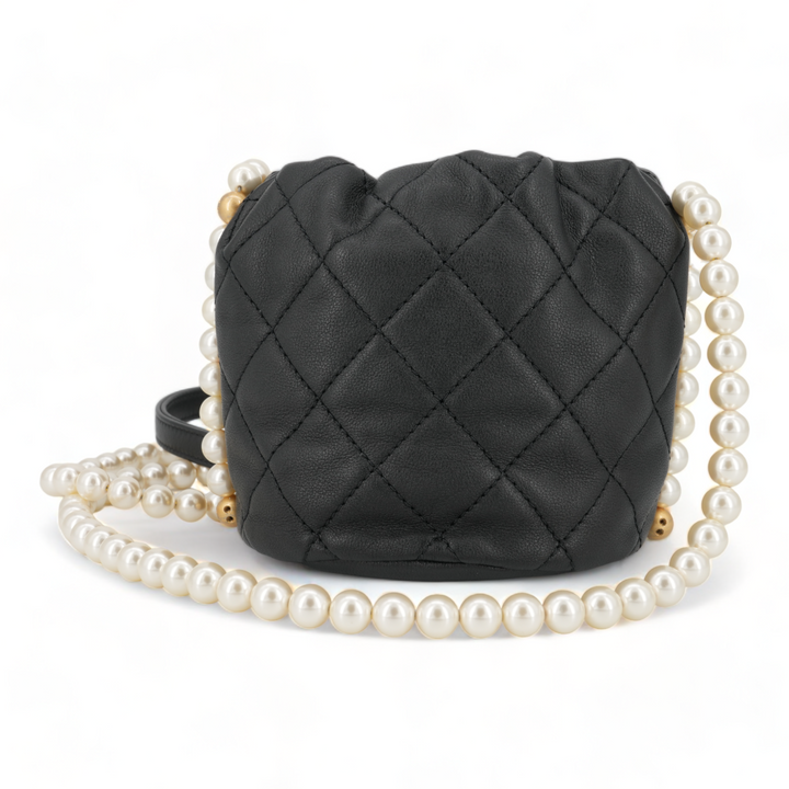 CHANEL Pearl Chain Drawstring Mini Bucket Bag in Black Lambskin - Replica Handbags Shopping
.com