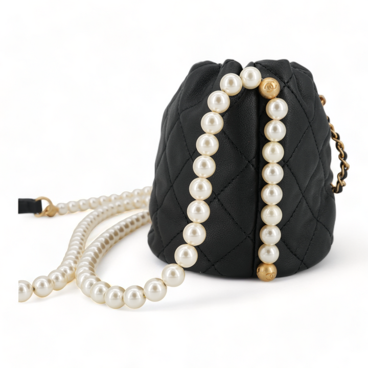 CHANEL Pearl Chain Drawstring Mini Bucket Bag in Black Lambskin - Replica Handbags Shopping
.com