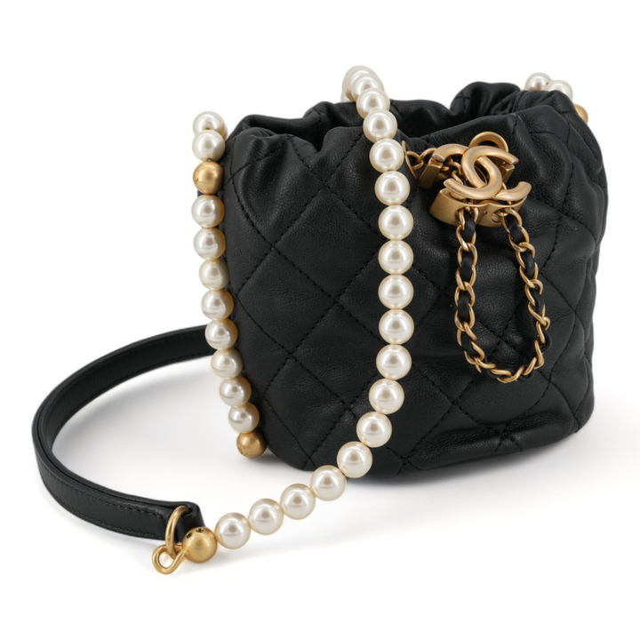 CHANEL Pearl Chain Drawstring Mini Bucket Bag in Black Lambskin - Replica Handbags Shopping
.com